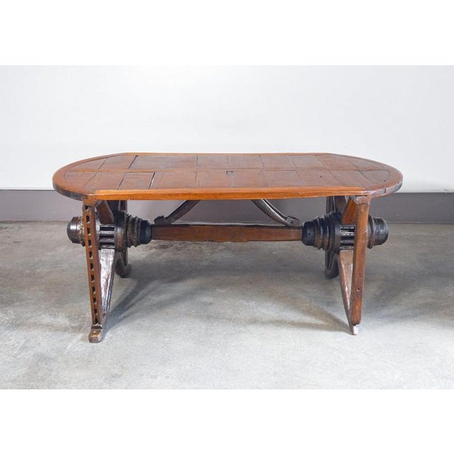 Rustic handcrafted table entirely in solid wood, made with the elements of an old wagon, in particular the axle and its...