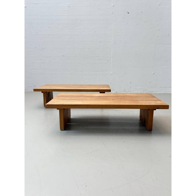 Two exceptional, low-profile coffee tables made of heavy, solid wood, dating from the 1970s. The tabletops consist of...