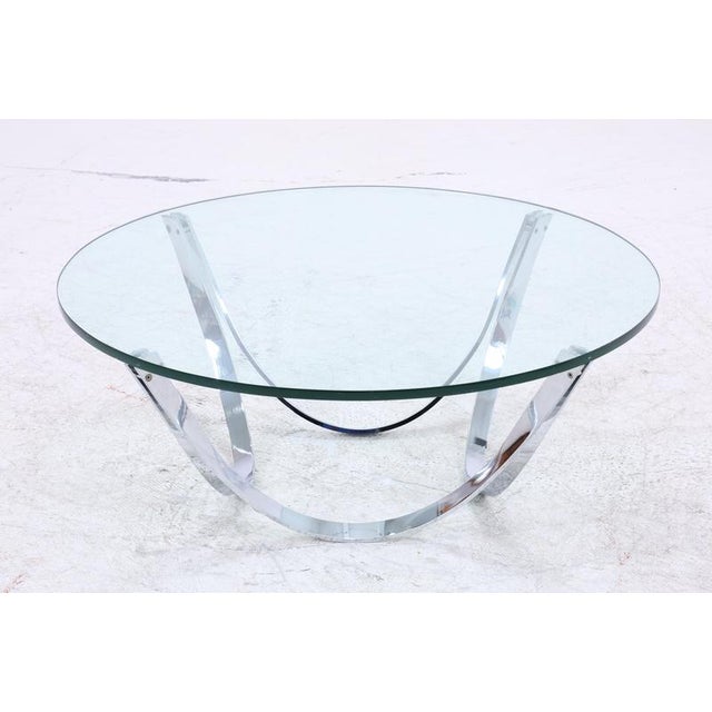 Iconic vintage coffee table by Werner Lindner for Bacher with a round glass top and striking chrome-plated frame. The...