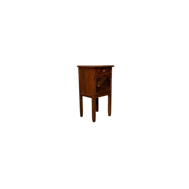 This vintage walnut bedside table features compact proportions and simple lines. It features a practical upper drawer and...