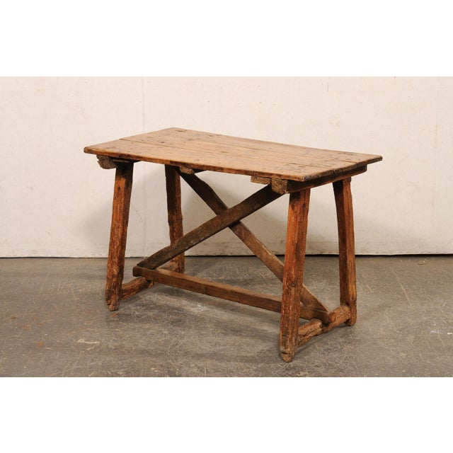 A Spanish wood occasional table or smaller-sized desk from the 18th century. This antique table from Spain is rustic and...