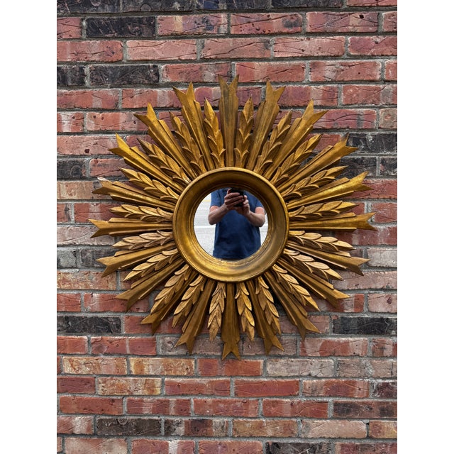 This is a gorgeous gilt wood mirror! Done in layered sunburst style, there are several layers of rays made up of...