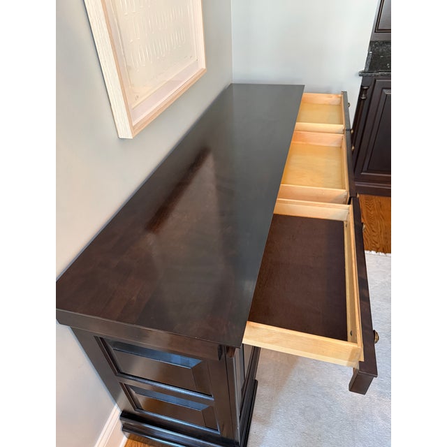 Classic traditional sideboard / buffet cabinet purchased new from Walter E around 2008. Smith. Features a rich dark wood...