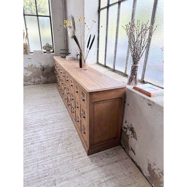 A vintage pharmacy cabinet from the 1950s. We love its extra-large dimensions, its considerable length, and its limited...