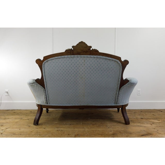 This magnificent late 19th-century Victorian settee is a breathtaking testament to old-world elegance and master-level...