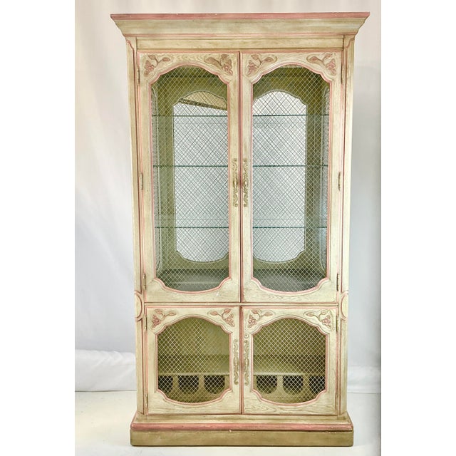 This is a stunning wood and mesh Display Cabinet from Habersham Furniture in the Rustic Mediterranean style. It features a...
