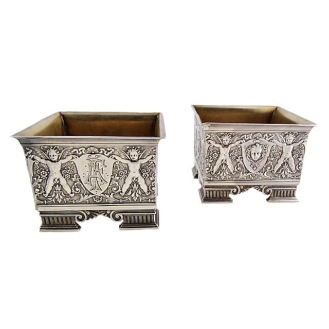A fine and beautiful pair of Victorian sterling silver salts circa 1865. Each square in form and decorated in a...