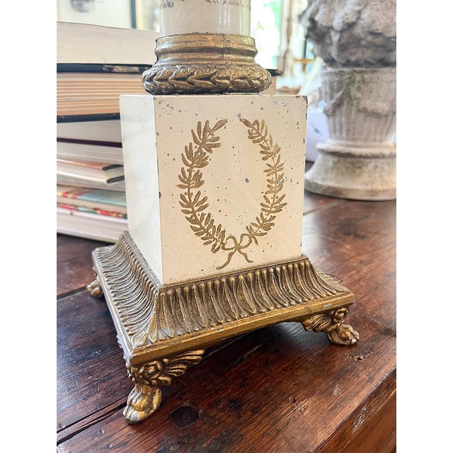 This stunning pair of tole lamps has cream bases with gold detailing throughout. The lamps feel substantial and sturdy....