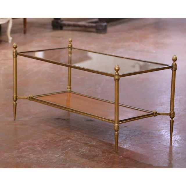 This elegant two-tier coffee table was crafted in France by Maison Jansen circa 1940 and exemplifies the refined...