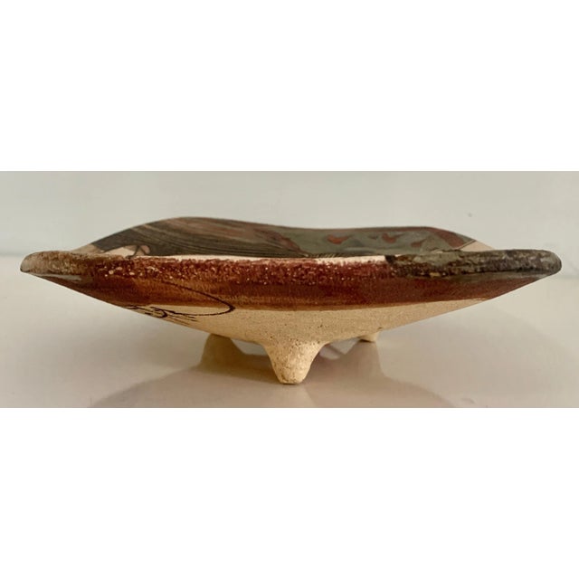 A wonderful terracotta plate with tripod legs - painting in the manner of Picasso - stamped and with original tag Could be...