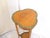 This Edwardian satinwood table has a green painted leafy decorations.