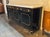 The Louis XVI Style Piano Black Sideboard with a Marble Top is a luxurious and elegant piece of furniture. Featuring a...