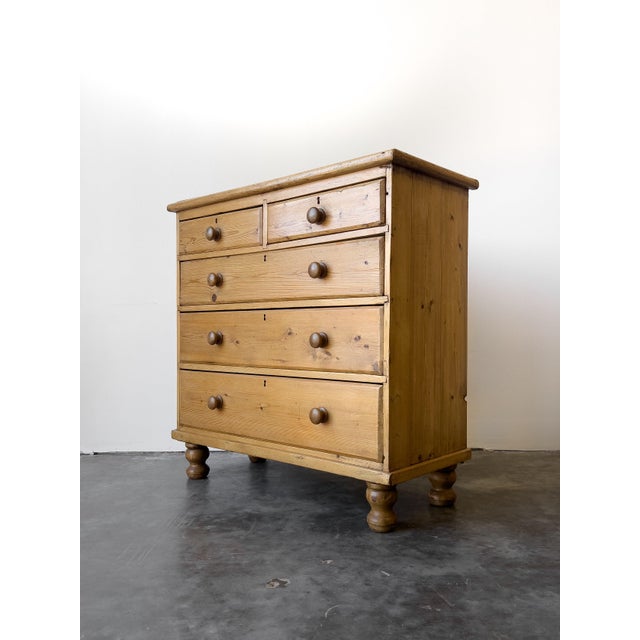This classic English antique Victorian 2-over-3 chest of drawers is crafted from solid pine, with rich character and...