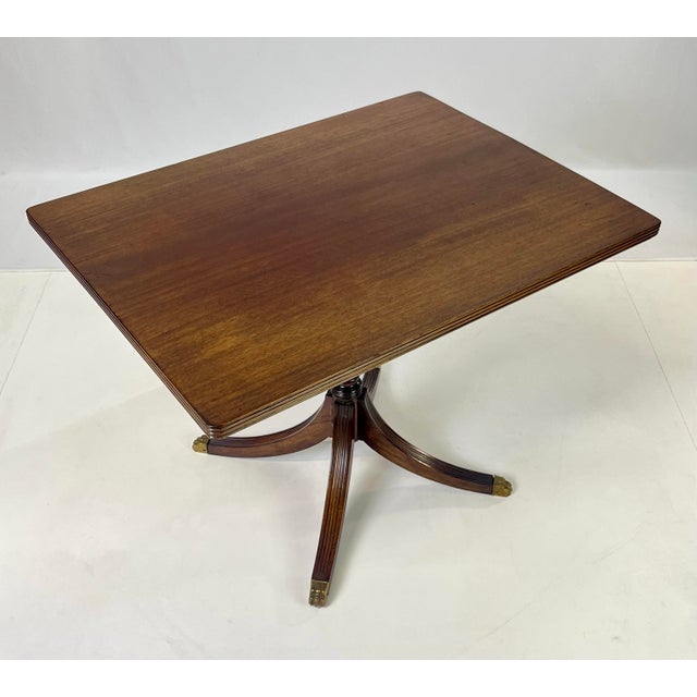 An authentic mid-century mahogany lamp table by Kittinger (Model A 218). This piece features a classic Federal-inspired...