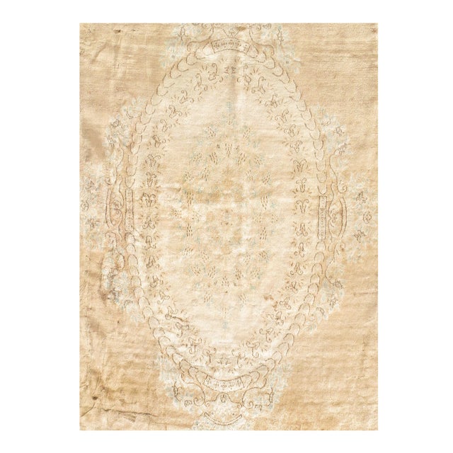 Drawn in Kerman’s distinctive floral style, this striking antique Persian medallion rug features a beautiful feminine...