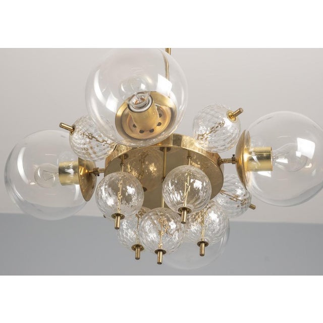 This chandelier was designed by Jaroslav Bejvl and manufactured in the 1970s in Czechoslovakia by Kamenický Šenov, a...