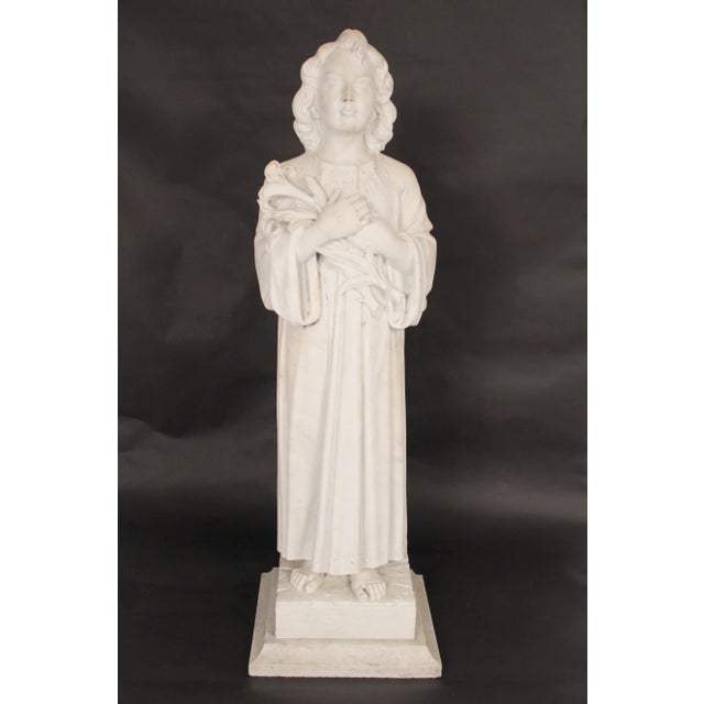 48" tall white marble statue of a young girl holding a bouquet of flowers, on a Carrera marble base, circa 1920's.