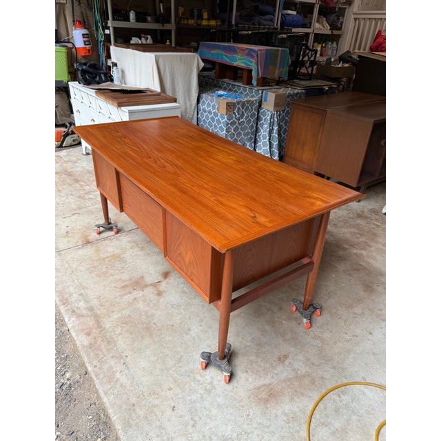 Beautiful Danish modern executive desk designed by Arne Vodder, made in Denmark (marked) in the 1960’s. The top, drawers...