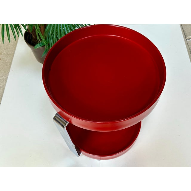 Ruby-red space-age serving trolley from Germany, manufactured in the 1960s. The two round plastic trays are held by a slim...