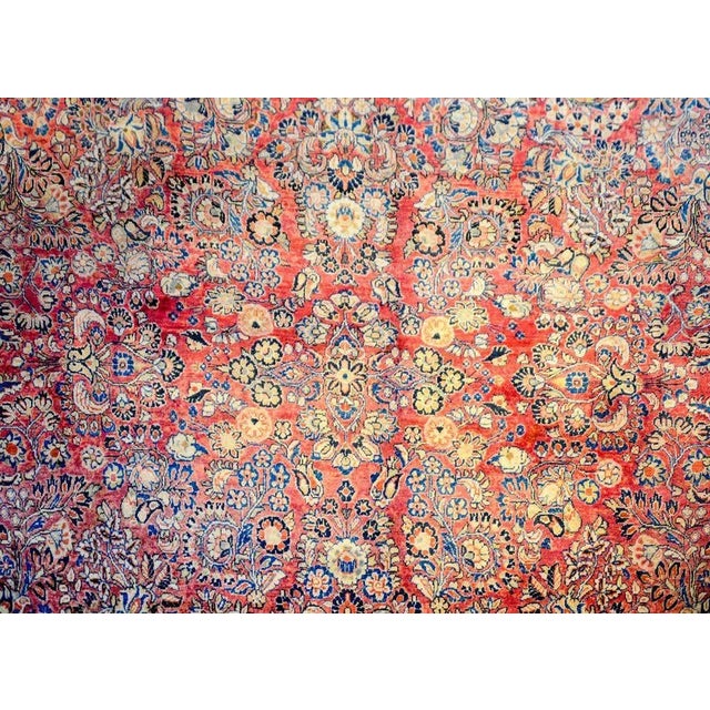 An exceptional early 20th century Persian Sarouk rug with a beautiful mirrored floral and vine pattern woven in light and...
