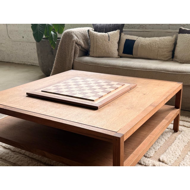 Some objects become part of the moments that surround them. A chessboard is more than a surface for a game. It is a place...