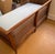 A sweet mid-century cane settee. The wood frame features slightly flared arms and tapered legs with carved wood floral...