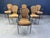 Vintage wrought iron and wicker bistro/dining chairs designed by Frederick Weinberg. Elegant black wrought frame with a...