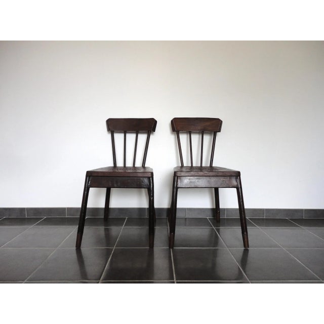 This pair of chairs was made in France. The structure is made from metal with a faux wood paint, the backrest and the seat...