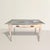 This late 19th-century American garden table refuses polish in favor of presence. The zinc top—softly dimpled, mottled,...