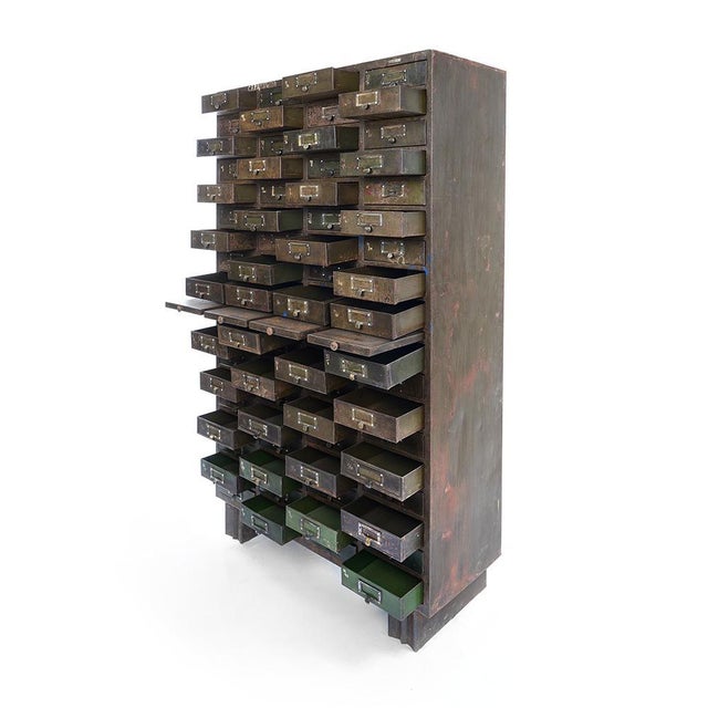 Large metal workshop cabinet with 72 drawers and 4 shelves. This piece is designed in the style of the selected designer...