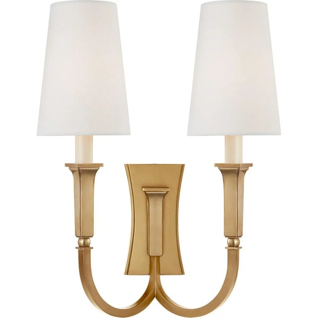 Delphia Large Double Arm Sconce in Hand-Rubbed Antique Brass with Linen Shade Designer: Thomas O'Brien Height: 17"...