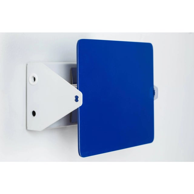 Charlotte Perriand blue 'Applique Á Volet Pivotant' wall light. A clean and iconic design executed in blue and white...