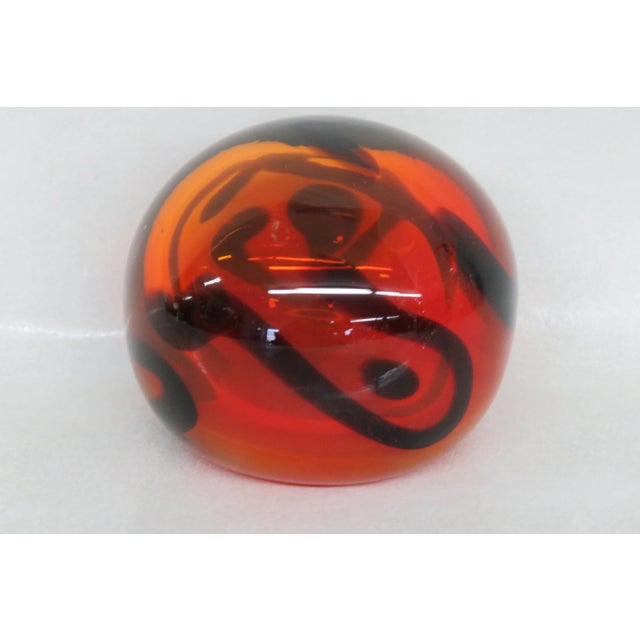 This stunning paperweight is made of hand blown glass. This beautiful paperweight has a classic silhouette, a brilliant...