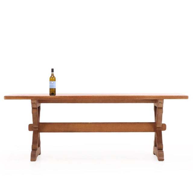 A handsome French oak dining table distinguished by its bold architectural form and timeless design. The substantial...