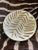 Fabulous enameled metal decorative plate, dating to the 1980’s. Off-white and gold enamel featuring an organic palm leaf...