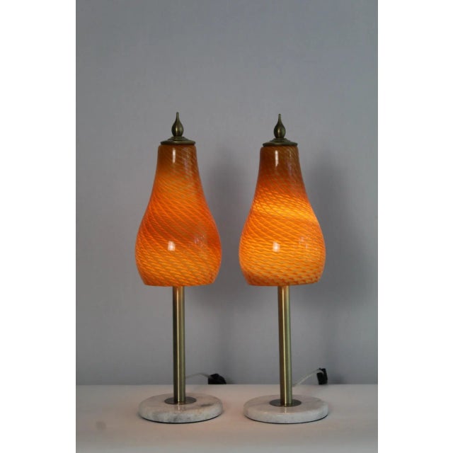 A pair of petite Mezza Murano style lamps. Simple sleek design. Graceful pear shape hand blown glass shades. Mounted on...