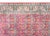 This vintage Anatolian silk runner features a vibrant red field adorned with an intricate, all-over floral and vine scroll...