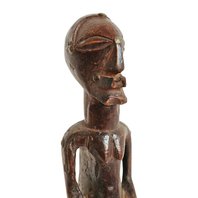 Old rare carved wood Songye female figure from Democratic Republic of Congo. Beautiful signs of age and use.