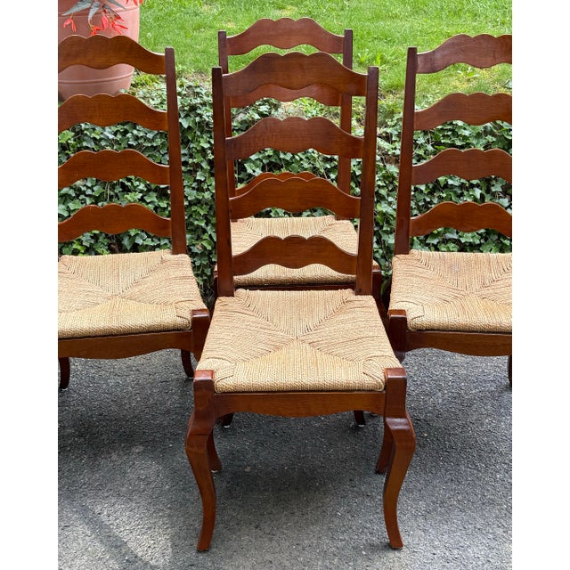 Beautiful set of 4 solid hardwood dining chairs. Features Ladderback construction, elegant cabriole legs, woven seats and...