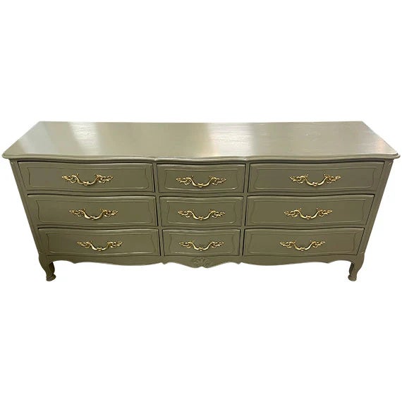 This dresser feels elevated, romantic, and quietly luxurious. The olive green finish gives a traditional French Provincial...