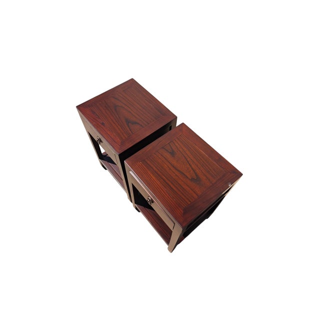 This pair of elegant Asian accent tables is handmade from solid elm. With a single drawer and four elegantly shaped legs...