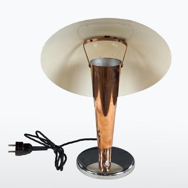 Early Napako table lamp from the 1930s–40s with a mushroom-shaped copper shade and tapered copper body. Chrome base adds...