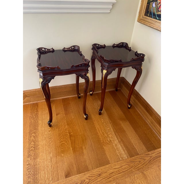 Two matching, elegant side tables that would go perfect next to a bed or couch.