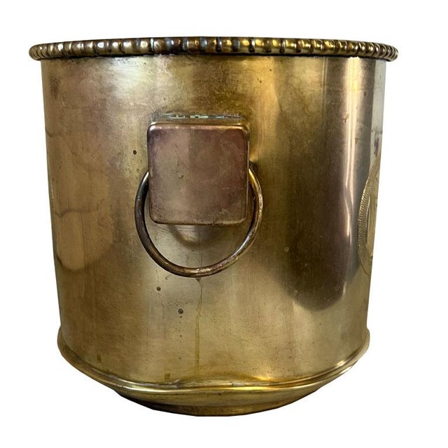 This exquisite early 20th-century French brass cachepot, ice bucket, or wine cooler embodies the elegance and...