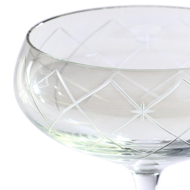 A stunning addition to any bar collection, this set of four coupe glasses features lustrous, hand-painted color cups with...