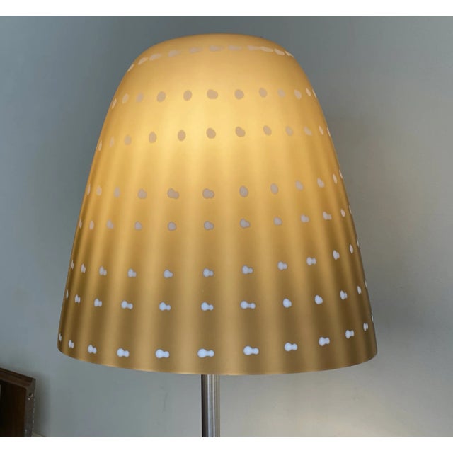 This amazing floor lamp has 2 bulbs, brushed nickel base and a hand blown art glass shade which is frosted cream color...