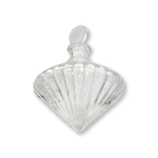 Like a crystal top frozen mid-spin, this sculptural decanter brings a playful sense of movement to the bar. Inscribed on...