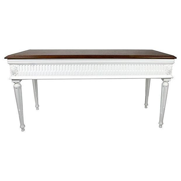 Circa 1960s; Neoclassical-style desk with fluted legs, an arched coved center, and brass pull hardware. Newly...
