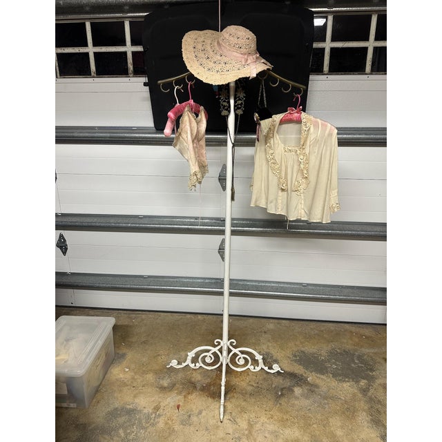 Unusual and striking vintage floor-standing garment and accessory stand featuring an elegant brass upper section paired...