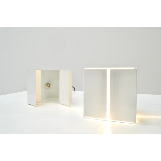 Very rare cubic-shaped table lamps, designed by Paolo Tilche for Sirrah in 1970s Italy. Each lamp features four removable...